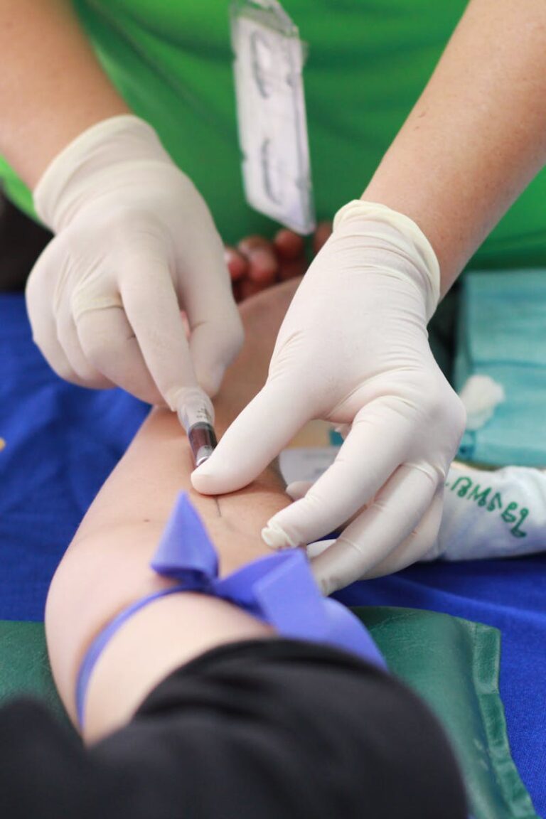 A healthcare professional administering an injection to a patient's arm during a medical procedure.